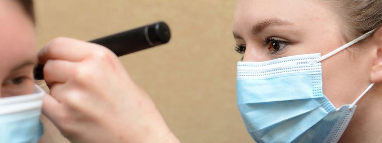 Healthcare professional examining a patient